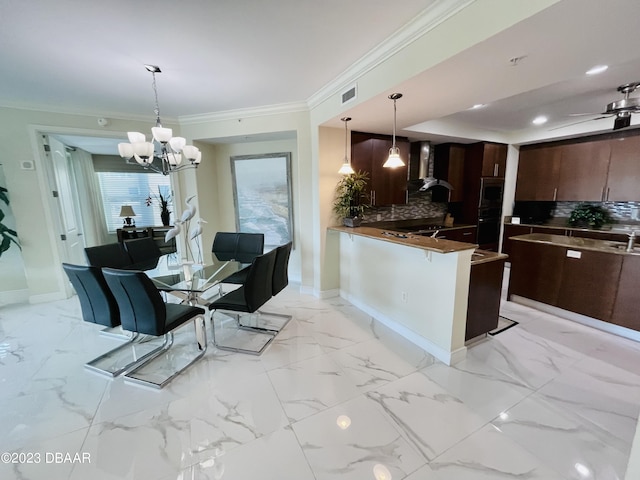 1925 S Atlantic Ave Unit 411, Daytona Beach Shores, FL 32118 - kitchen featuring wall chimney exhaust hood, a chandelier, tasteful backsplash, baseboards, and modern cabinets