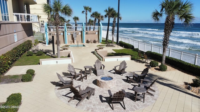 1925 S Atlantic Ave Unit 411, Daytona Beach Shores, FL 32118 - view of patio with an outdoor fire pit and view of water and beach