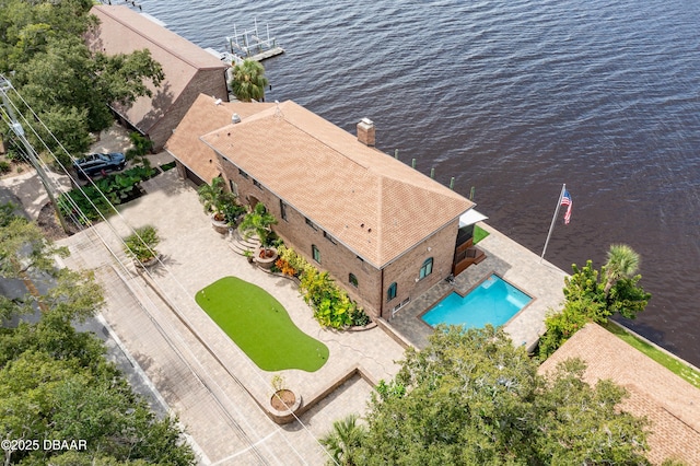 birds eye view of property with a water view