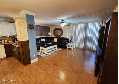 living room featuring ornamental molding, hardwood / wood-style flooring, and ceiling fan