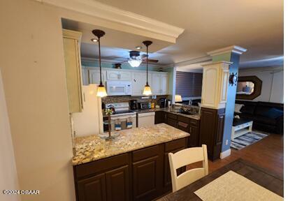 kitchen featuring dark hardwood / wood-style flooring, hanging light fixtures, decorative columns, ceiling fan, and light stone countertops