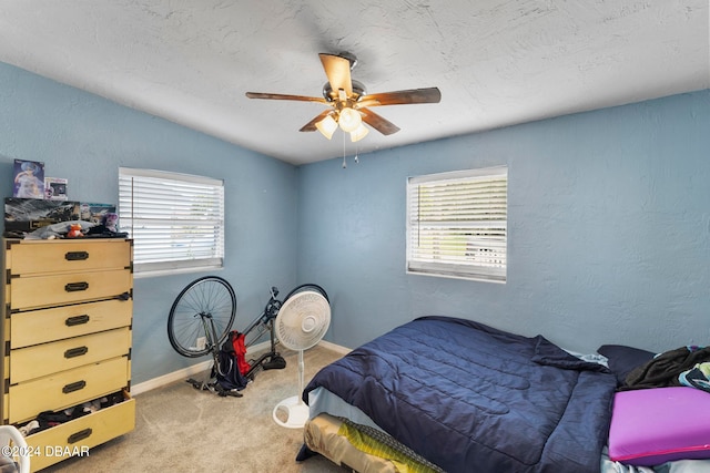 carpeted bedroom with multiple windows, vaulted ceiling, and ceiling fan