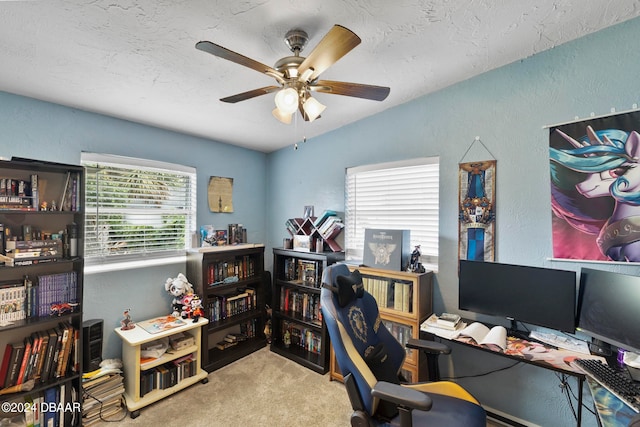 carpeted home office featuring a wealth of natural light and ceiling fan