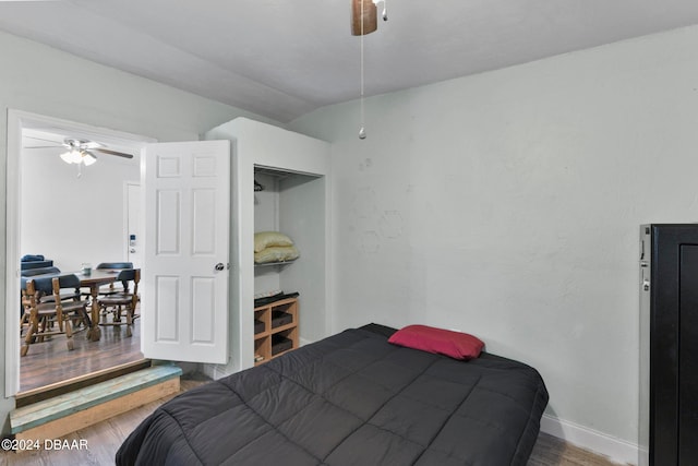 bedroom featuring hardwood / wood-style flooring, ceiling fan, and vaulted ceiling