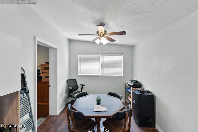 dining area featuring dark hardwood / wood-style flooring, vaulted ceiling, ceiling fan, and a textured ceiling