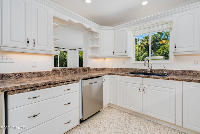 kitchen featuring dishwasher, white cabinets, and sink