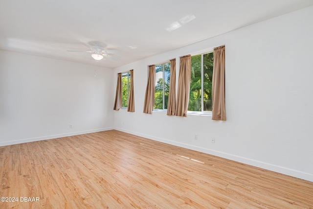 unfurnished room with ceiling fan and light wood-type flooring