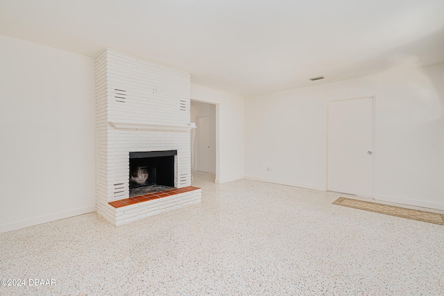 unfurnished living room with a brick fireplace