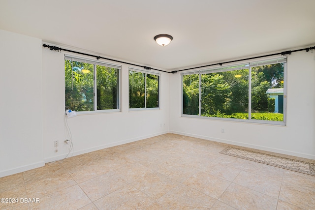 unfurnished room with light tile patterned floors