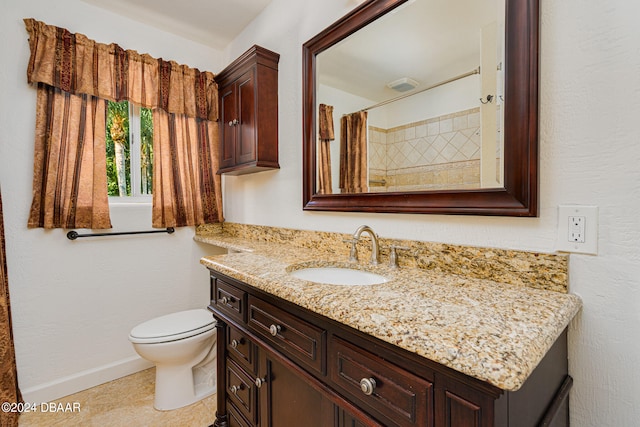 bathroom with tile patterned flooring, vanity, toilet, and walk in shower