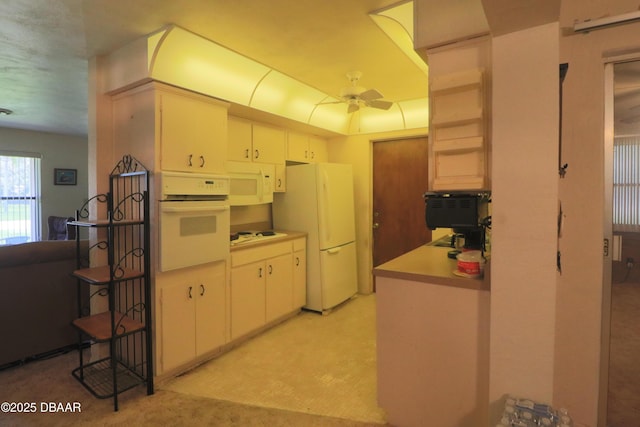 17 Putnam Ave, Ormond Beach, FL 32174 - kitchen with white appliances, ceiling fan, light countertops, white cabinetry, and light carpet