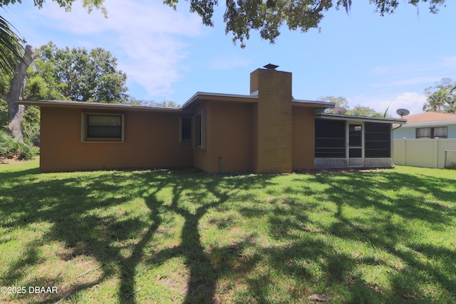 17 Putnam Ave, Ormond Beach, FL 32174 - back of house with a chimney and a sunroom
