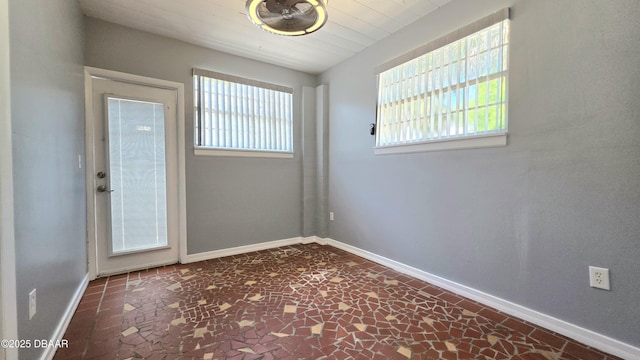 spare room featuring baseboards