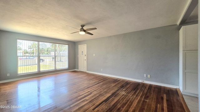 unfurnished room featuring ceiling fan, wood finished floors, and baseboards