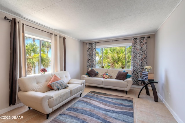 living area with light tile patterned floors, baseboards, a textured ceiling, and ornamental molding