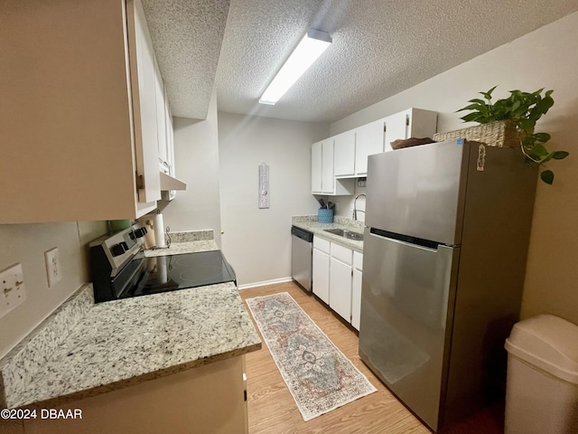 kitchen with white cabinetry, sink, light wood-type flooring, and appliances with stainless steel finishes