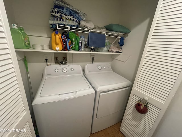 washroom featuring wood-type flooring and independent washer and dryer