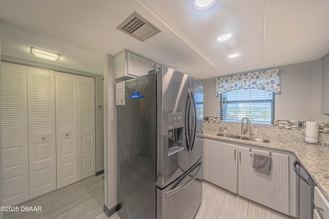 3800 S Atlantic Ave Unit 3030, Daytona Beach, FL 32118 - kitchen with appliances with stainless steel finishes, a sink, light stone countertops, decorative backsplash, and recessed lighting