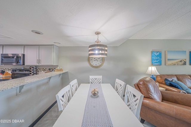 3800 S Atlantic Ave Unit 3030, Daytona Beach, FL 32118 - dining space featuring light wood finished floors