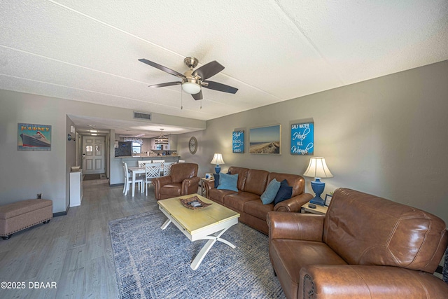 3800 S Atlantic Ave Unit 3030, Daytona Beach, FL 32118 - living area with a ceiling fan, wood finished floors, and a textured ceiling