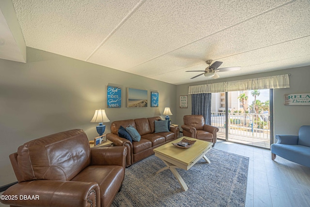 3800 S Atlantic Ave Unit 3030, Daytona Beach, FL 32118 - living area featuring a ceiling fan, wood finished floors, and a textured ceiling