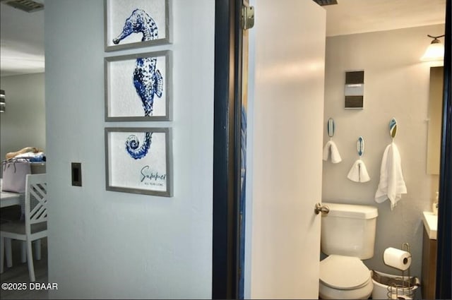 bathroom featuring vanity and toilet