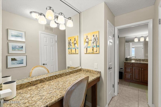 901 S Atlantic Ave Unit 202, Ormond Beach, FL 32176 - bathroom with tile patterned floors, vanity, and a textured ceiling