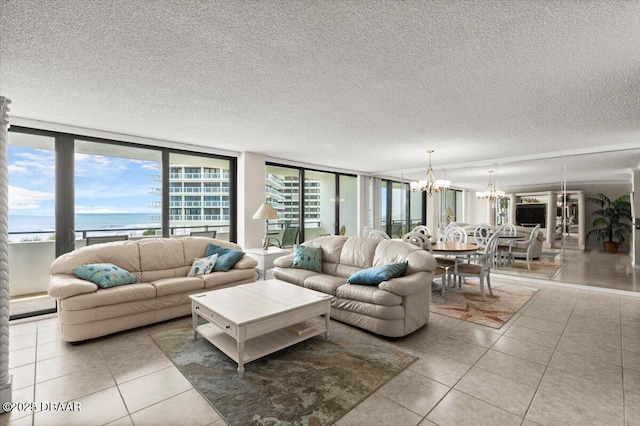 901 S Atlantic Ave Unit 202, Ormond Beach, FL 32176 - living room with a chandelier, tile patterned flooring, and a textured ceiling