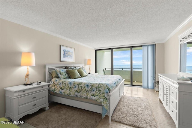 901 S Atlantic Ave Unit 202, Ormond Beach, FL 32176 - bedroom featuring access to exterior, crown molding, a textured ceiling, light tile patterned floors, and a water view