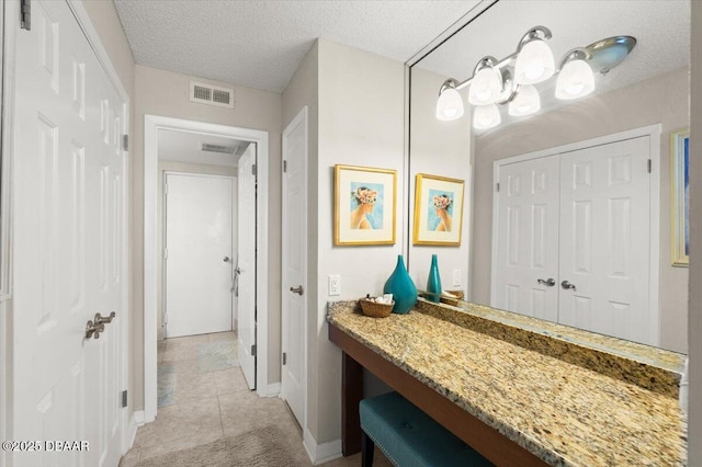 901 S Atlantic Ave Unit 202, Ormond Beach, FL 32176 - bathroom with a textured ceiling, tile patterned flooring, and vanity
