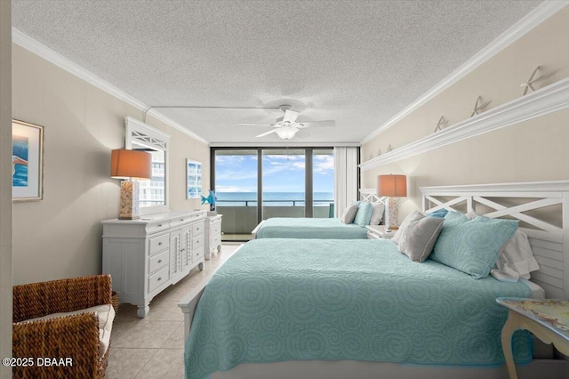 901 S Atlantic Ave Unit 202, Ormond Beach, FL 32176 - bedroom featuring access to exterior, a water view, a textured ceiling, ornamental molding, and light tile patterned floors