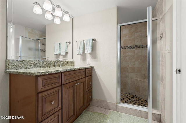 901 S Atlantic Ave Unit 202, Ormond Beach, FL 32176 - bathroom featuring a stall shower, tile patterned flooring, and vanity