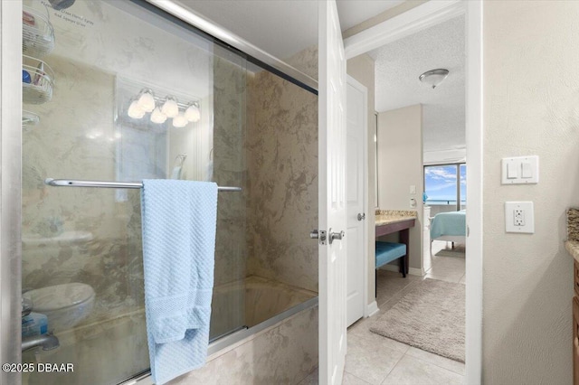 901 S Atlantic Ave Unit 202, Ormond Beach, FL 32176 - ensuite bathroom featuring tile patterned flooring, a shower with door, a tub with marble appearance, and vanity