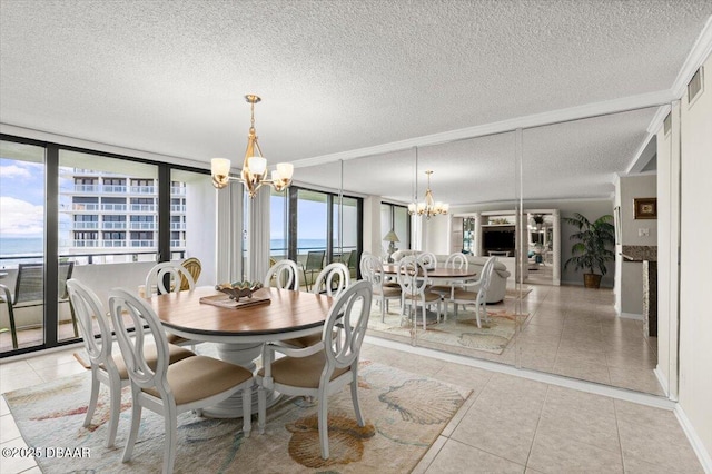 901 S Atlantic Ave Unit 202, Ormond Beach, FL 32176 - dining room featuring a chandelier, light tile patterned floors, a textured ceiling, and floor to ceiling windows