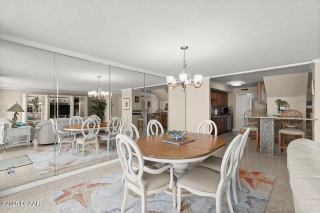 901 S Atlantic Ave Unit 202, Ormond Beach, FL 32176 - dining space with a chandelier, crown molding, light tile patterned flooring, and a textured ceiling