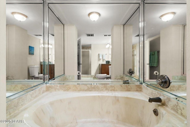 901 S Atlantic Ave Unit 202, Ormond Beach, FL 32176 - bathroom featuring a shower stall, a garden tub, and vanity