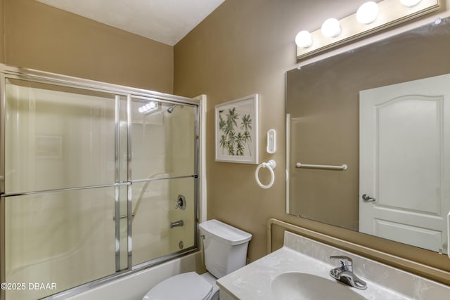 full bathroom featuring bath / shower combo with glass door, vanity, and toilet