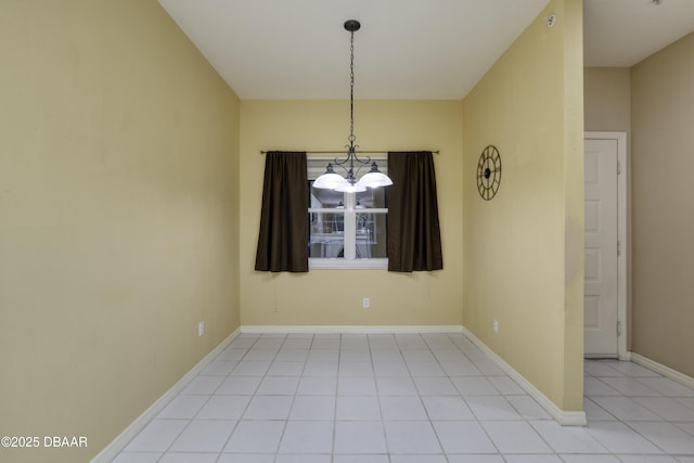 tiled empty room featuring a chandelier