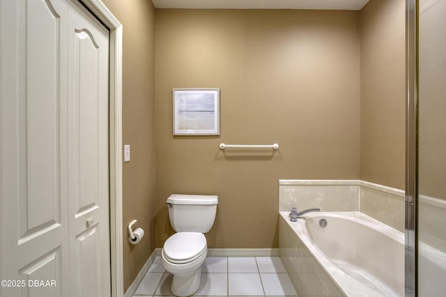 bathroom featuring tile patterned flooring, a bathtub, and toilet