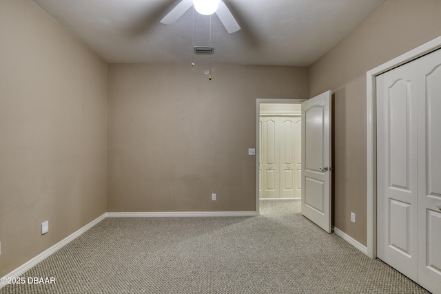 unfurnished bedroom with ceiling fan and light colored carpet