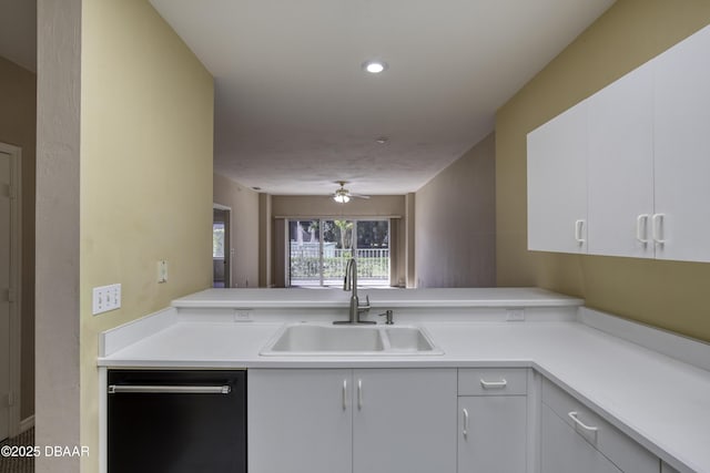 kitchen with sink, black dishwasher, kitchen peninsula, and white cabinets