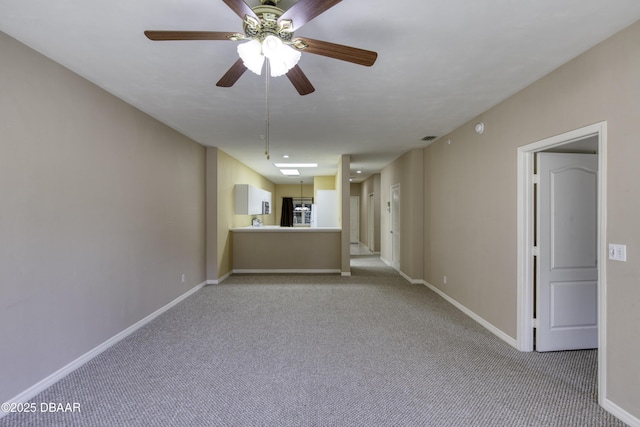 empty room featuring light colored carpet and ceiling fan