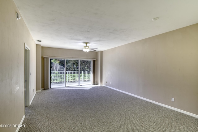 carpeted spare room featuring ceiling fan