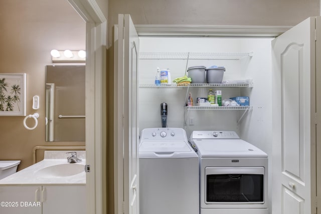 clothes washing area with separate washer and dryer and sink