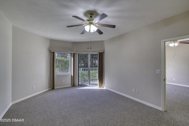 carpeted spare room with ceiling fan