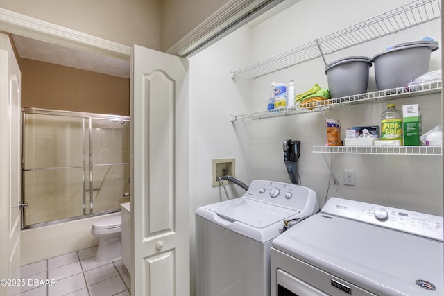 washroom with light tile patterned flooring and washer and clothes dryer