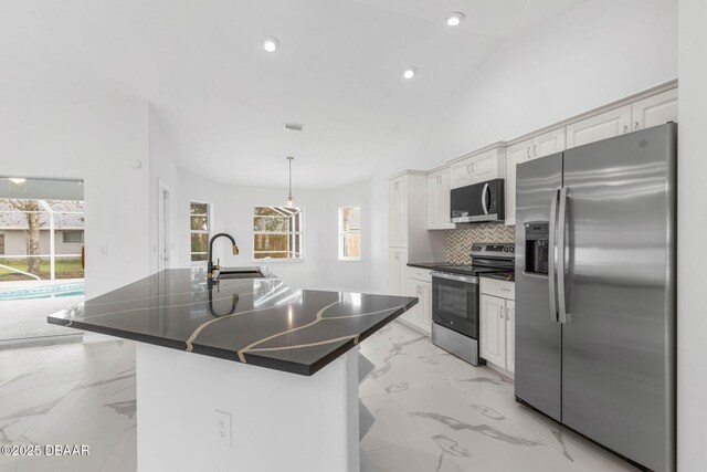 12 Patuxent Pl, Palm Coast, FL 32164 - kitchen featuring dark countertops, backsplash, appliances with stainless steel finishes, marble finish floor, and a sink
