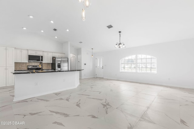12 Patuxent Pl, Palm Coast, FL 32164 - kitchen featuring visible vents, dark countertops, appliances with stainless steel finishes, and open floor plan