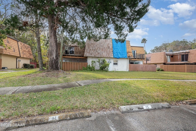 view of front of home featuring a deck and a front lawn