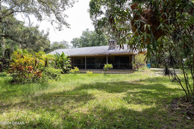 view of yard featuring a sunroom